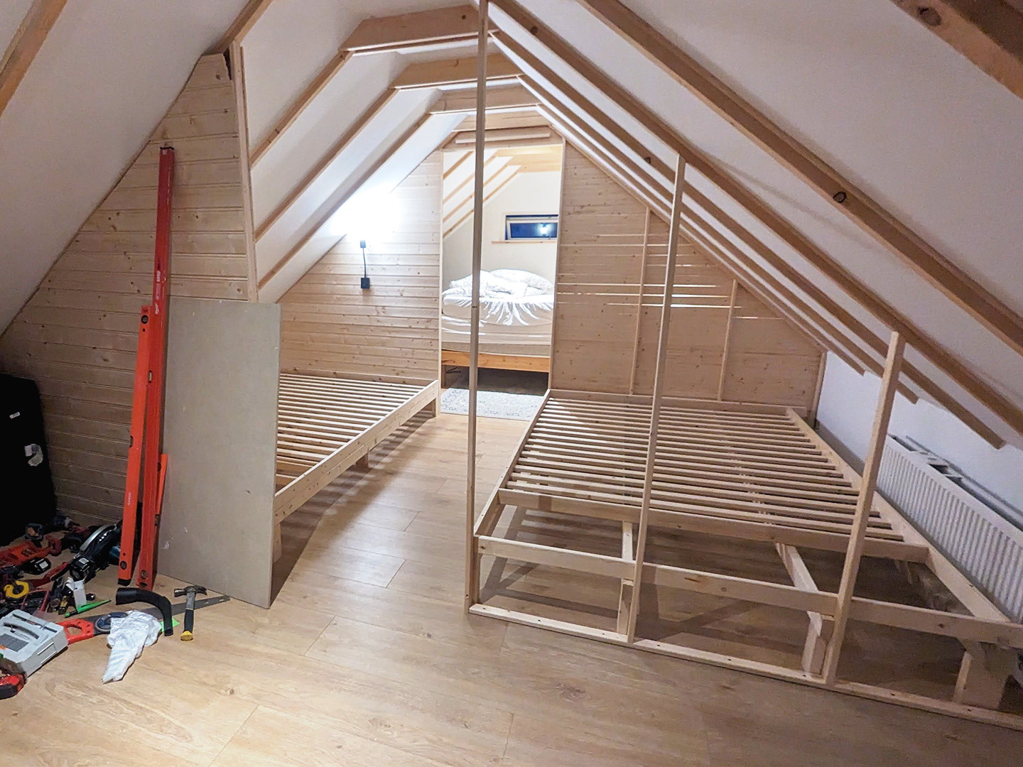 wooden attic construction with lighting and beds